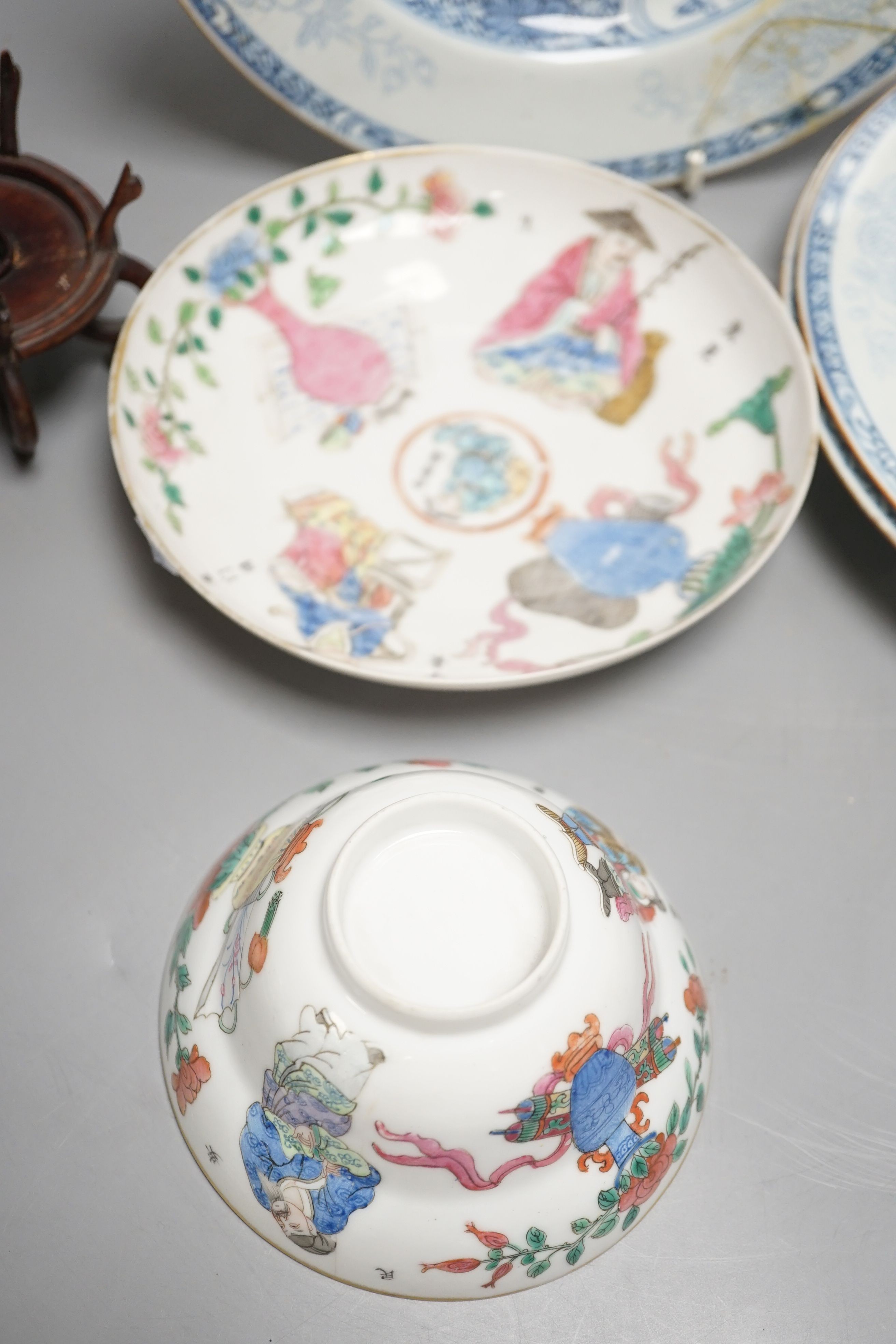 A 19th century Chinese famille rose bowl and saucer, a blue and white tea bowl on stand, a hardstone carving and three 18th century blue and white plates